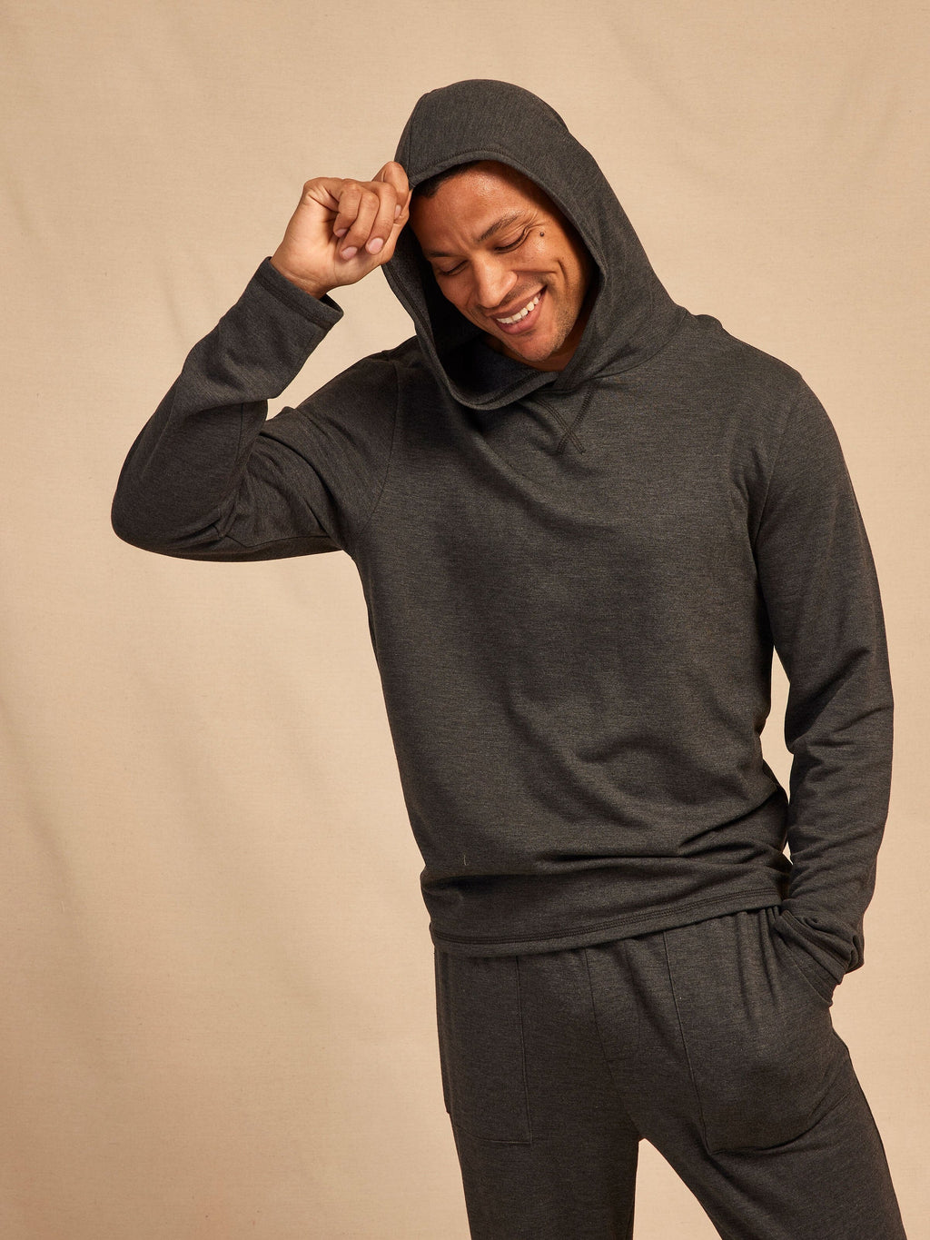 Men wearing a soft, lightweight grey Core Feather Fleece Hoodie with a relaxed fit.