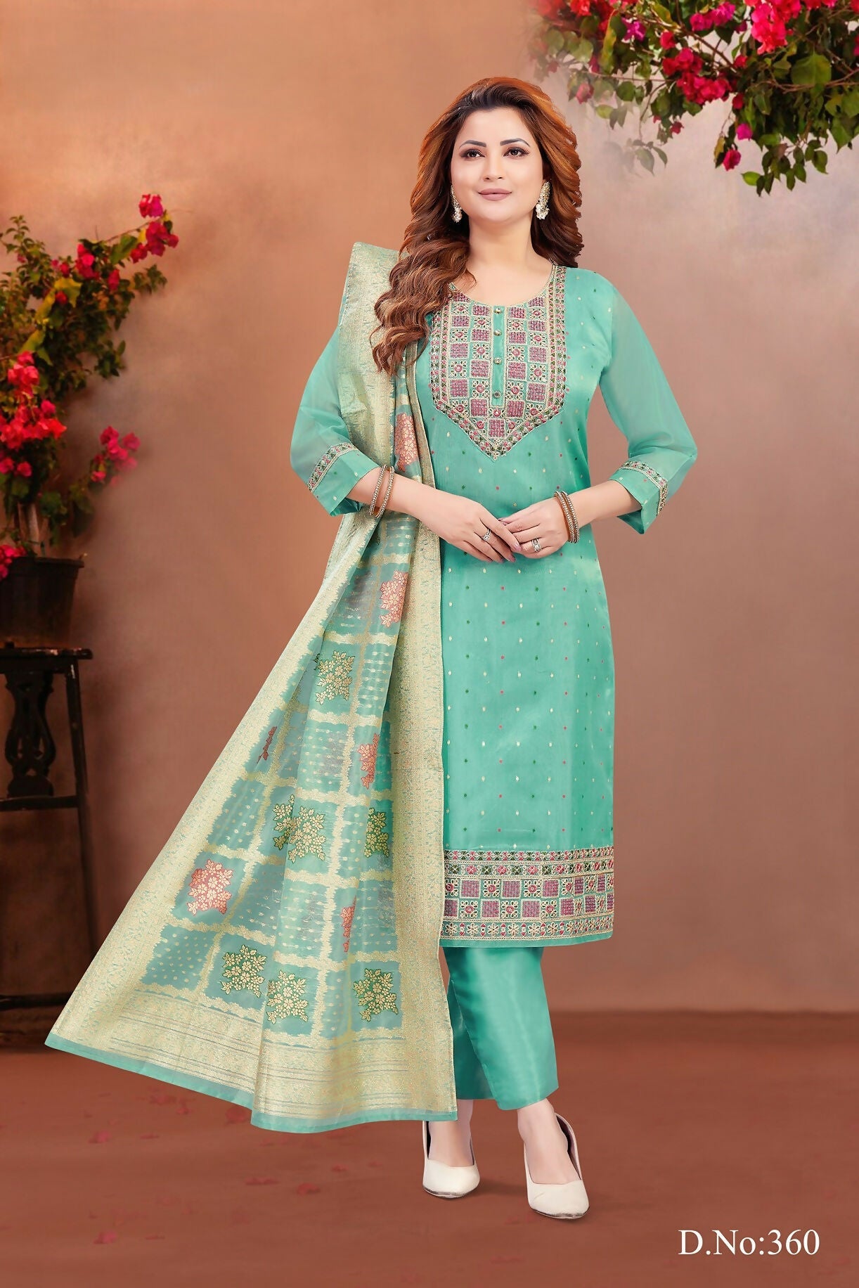 Women wearing a green brocade kurta set with intricate embroidery and round neck design