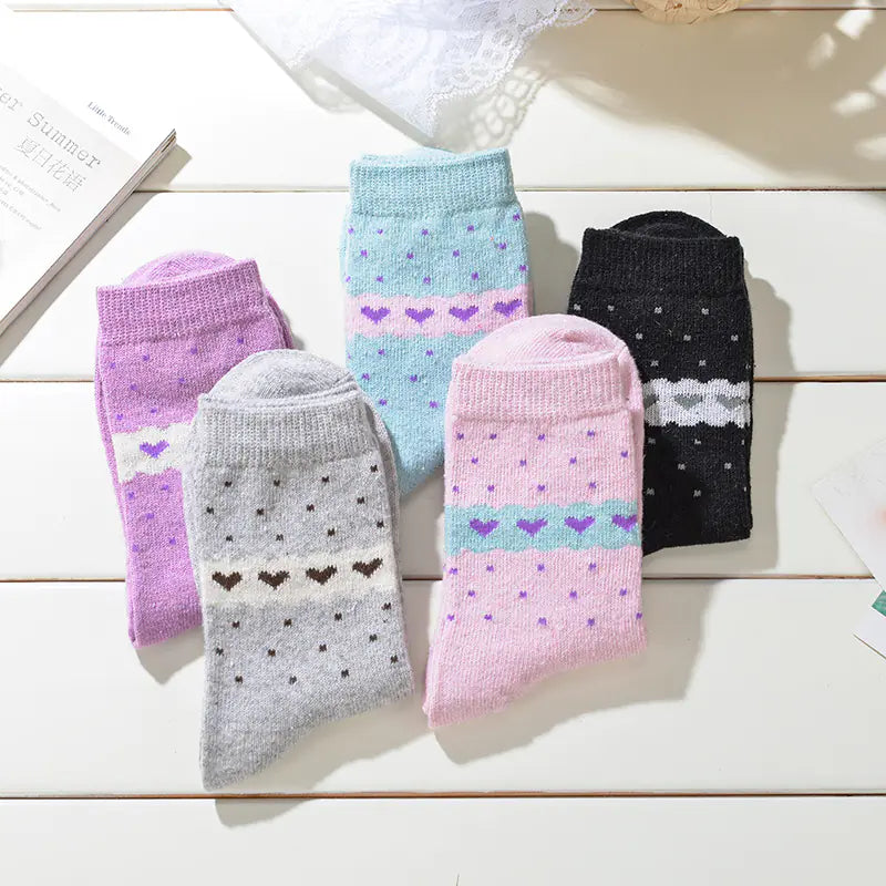 A selection of women's thick winter socks in various colors with heart and diamond patterns.