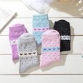 A selection of women's thick winter socks in various colors with heart and diamond patterns.