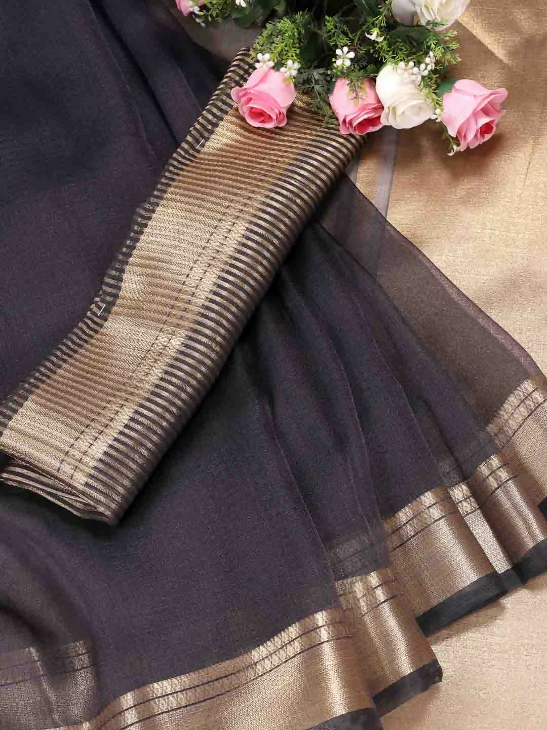 A beautiful grey organza saree with matching blouse fabric for a sophisticated festive look.