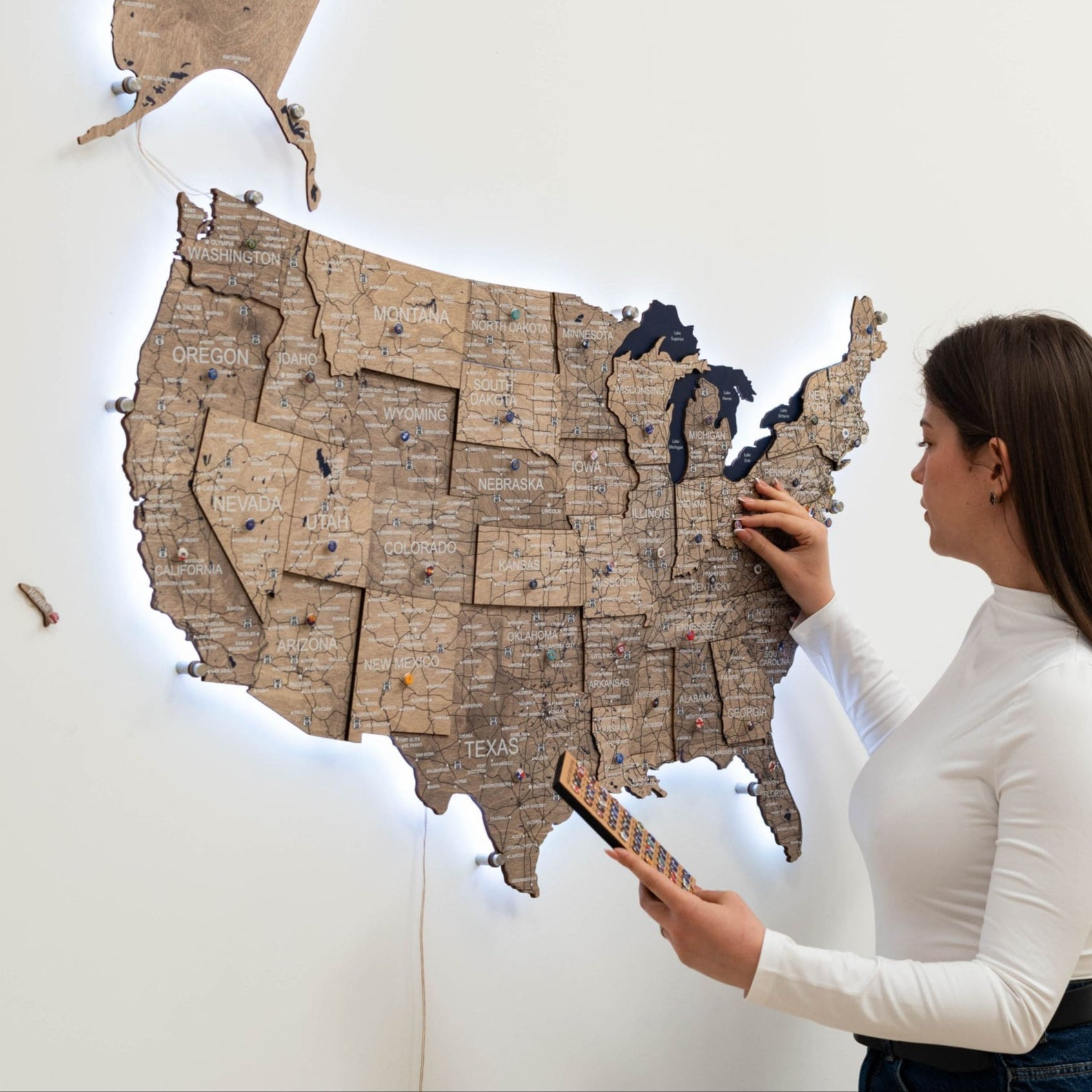 Wooden 3D LED Map of USA Terra finish hanging on a wall with ambient lighting