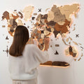 3D LED wooden world map with multicolor backlight installed on a minimalist living room wall