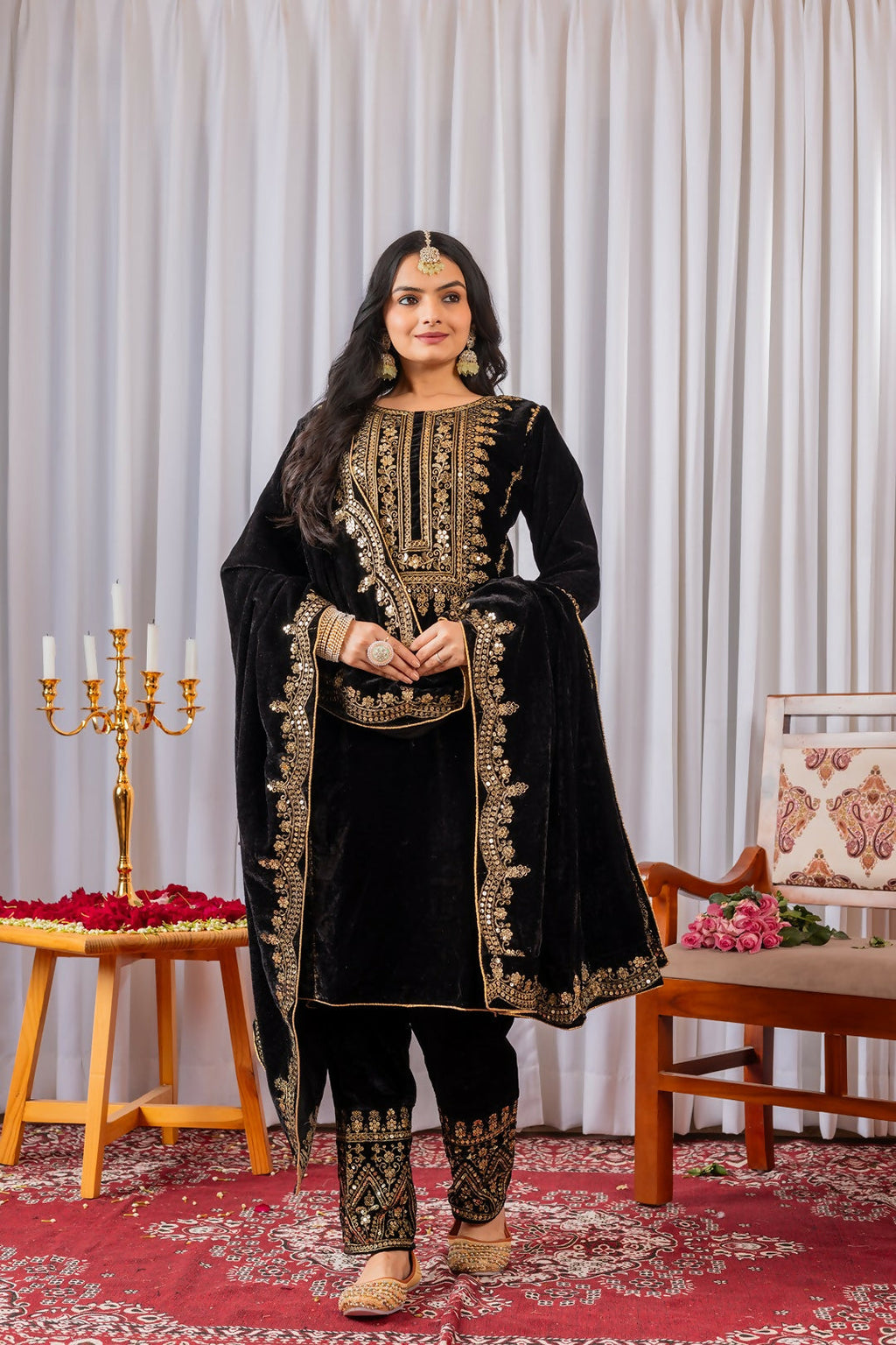 Model wearing a black velvet kurta set with detailed sequence embroidery work.