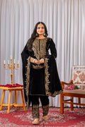 Model wearing a black velvet kurta set with detailed sequence embroidery work.