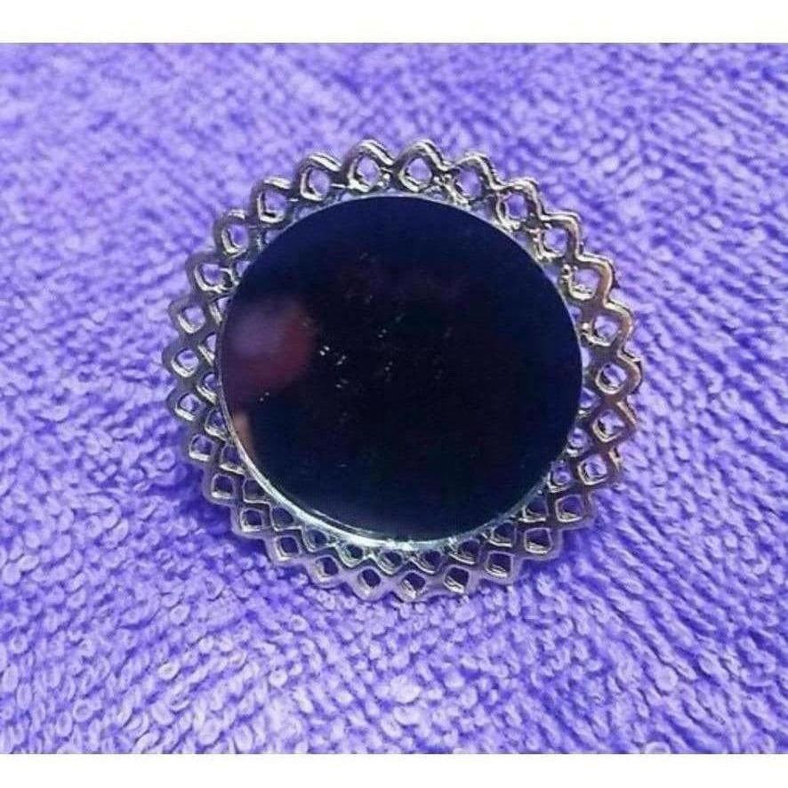 Close up of an elegant black stone statement ring on a female finger