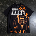 A man wearing a black graphic t-shirt with orange Invincible line art standing in a hobby shop
