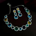 A glamorous multi-color AD stone statement necklace set with a silver-tone brass finish.