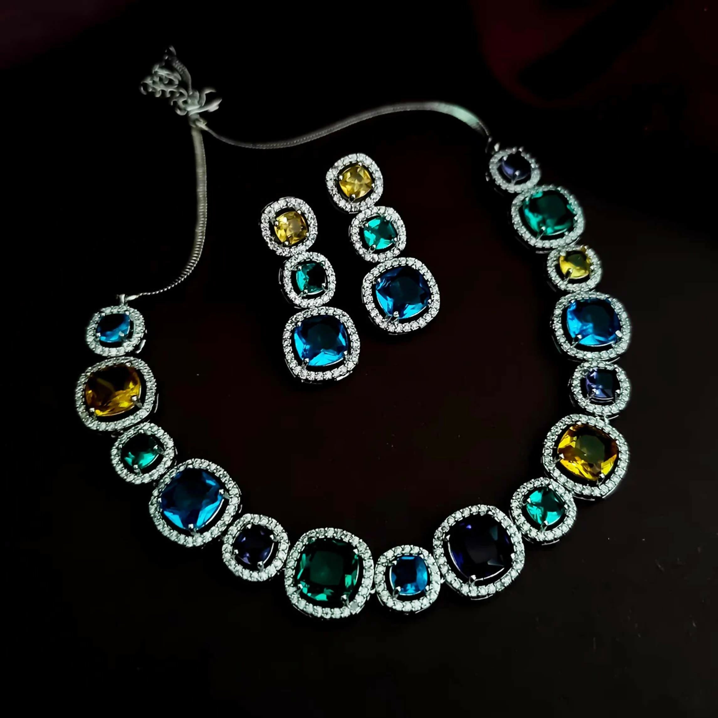 A glamorous multi-color AD stone statement necklace set with a silver-tone brass finish.