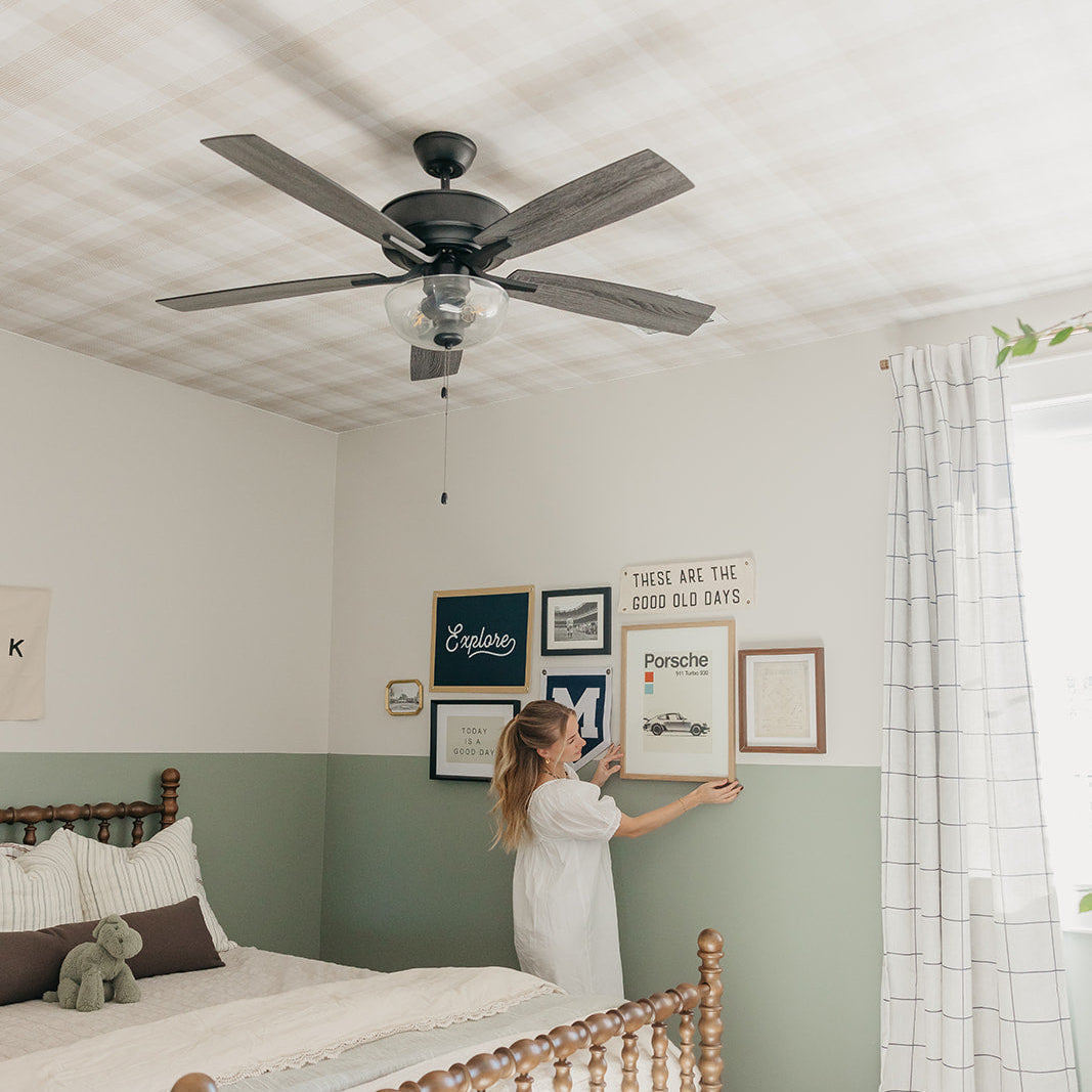 Cottagecore style floral wallpaper in green and white tones installed in a bohemian bedroom
