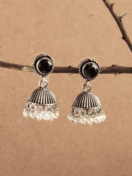 Johar Kamal oxidized silver jhumka earrings with central black stone detail worn by a model