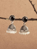 Johar Kamal oxidized silver jhumka earrings with central black stone detail worn by a model