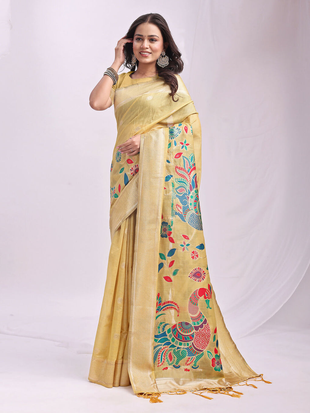 A woman wearing a solid yellow linen cotton traditional saree with a scoop neck blouse