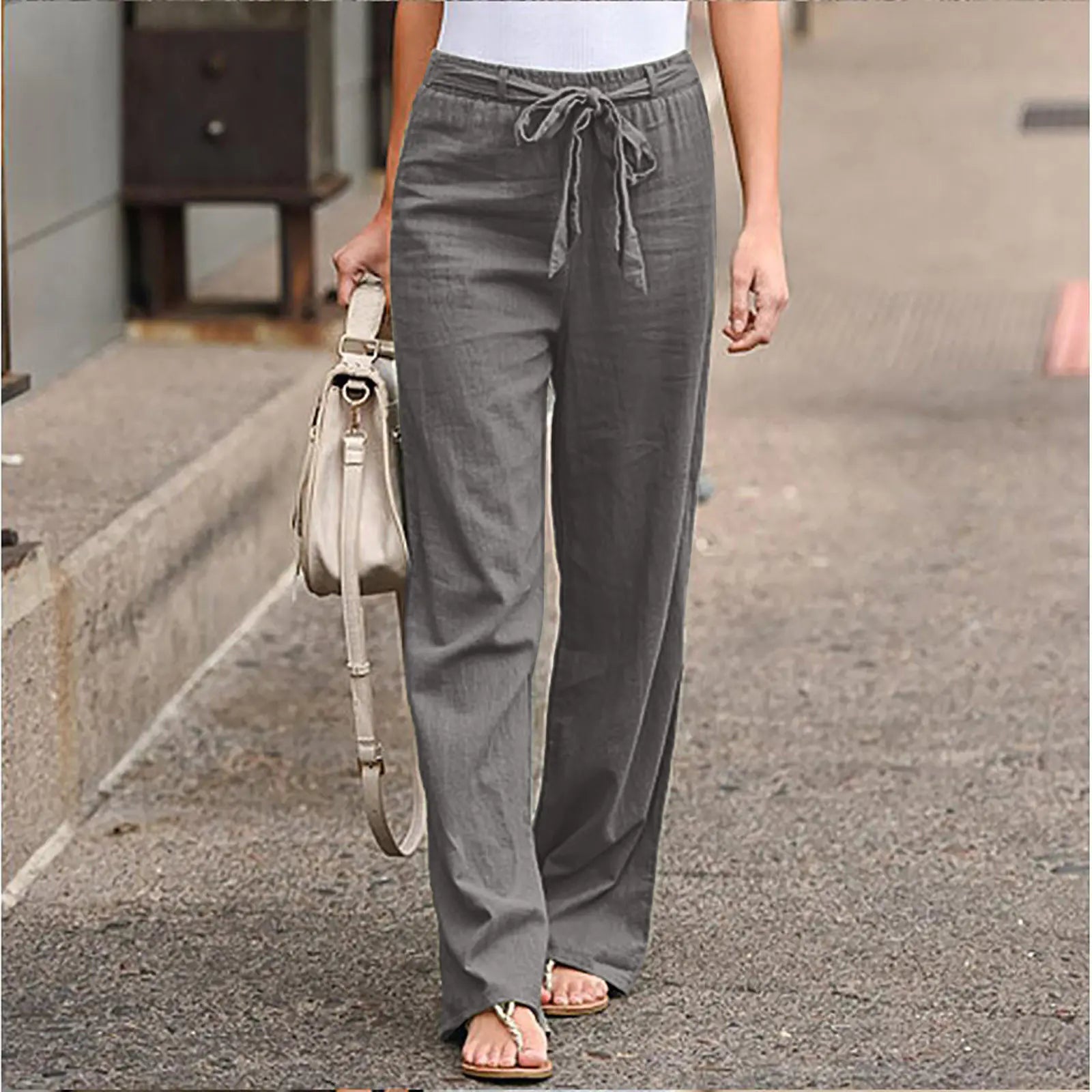 Model wearing casual grey wide-leg pants with a drawstring waist and sandals.