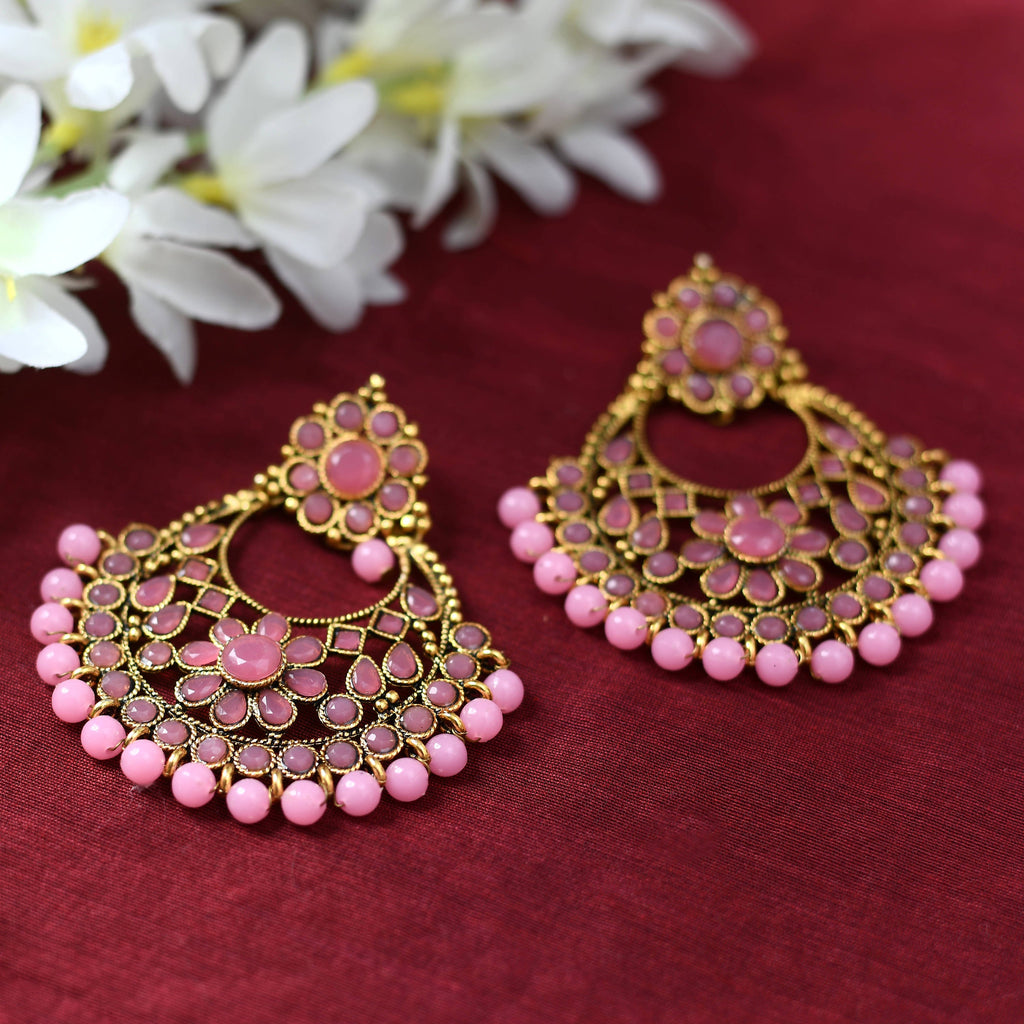 Elegant golden earrings with pink beaded detailing for a festive aesthetic