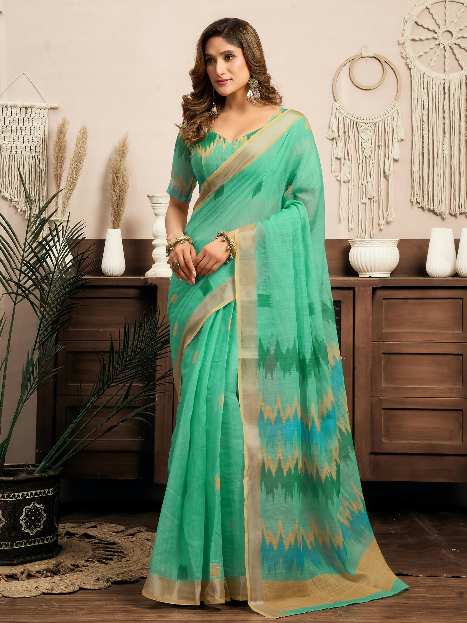 Teal green linen ready-to-wear saree featuring traditional Ikkat patterns with a matching unstitched blouse fabric