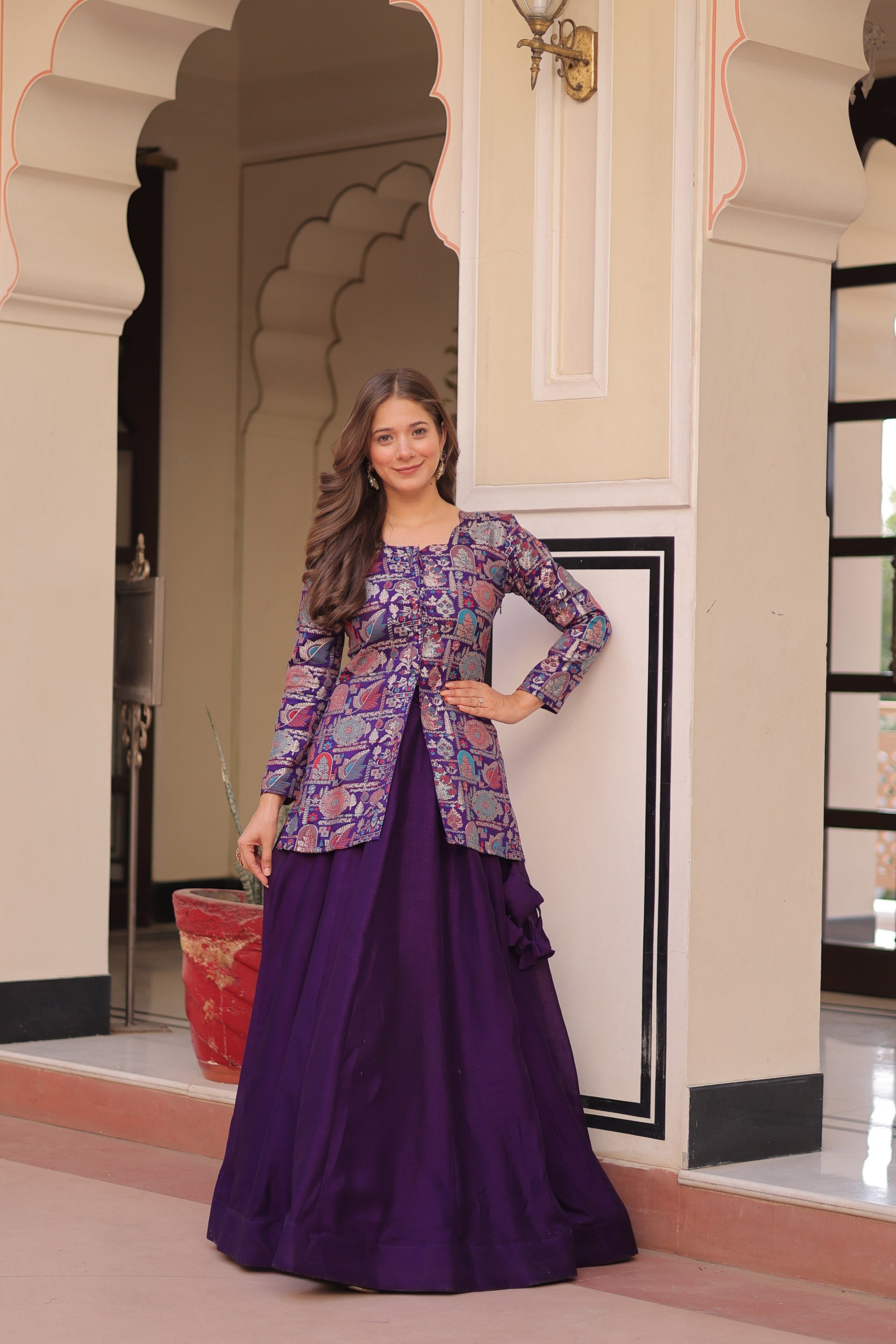 Woman wearing a purple Pure Simmer Vichitra lehenga with intricate kali pattern and canvas patta border