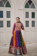 Woman wearing a multi-color georgette lehenga with traditional Kutchi Gamthi embroidery for Navratri