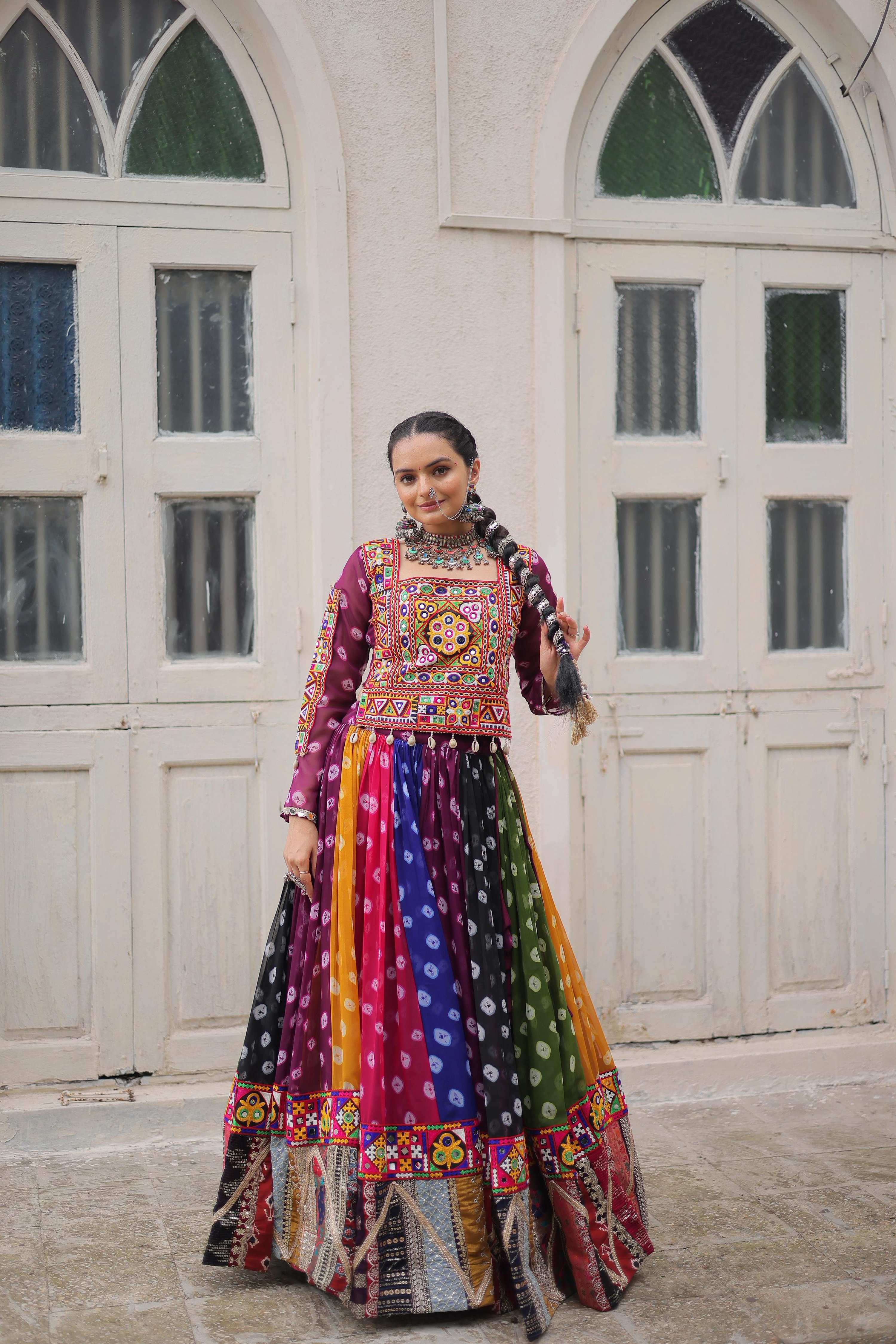 Woman wearing a multi-color georgette lehenga with traditional Kutchi Gamthi embroidery for Navratri