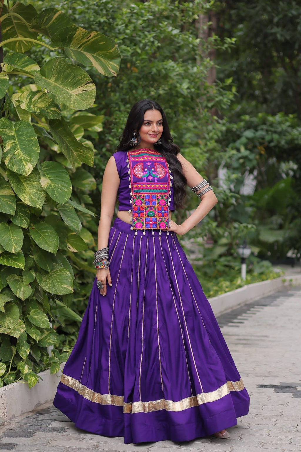 Purple Roman Silk Navaratri lehenga with vibrant Kutchi Gamthi embroidery and mirror work detailing.