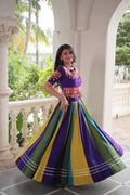Vibrant striped Roman Silk lehenga choli in purple, yellow, green, and blue with detailed Gota lace embroidery.