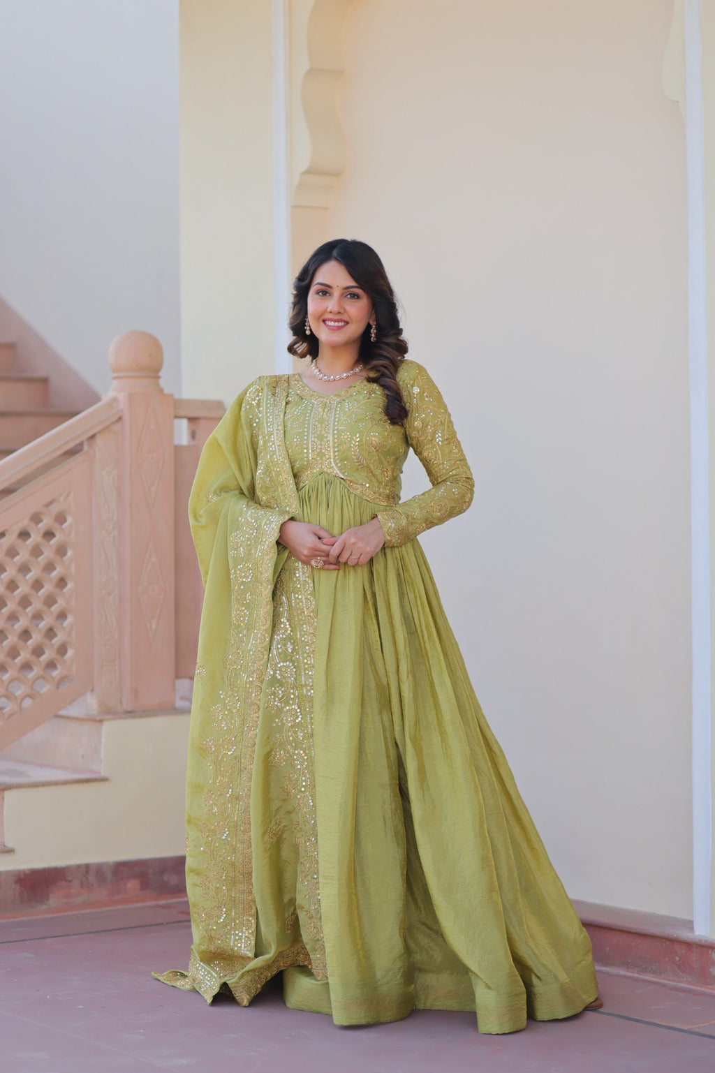 Vibrant parrot green gown in gold-crush fabric with sequins and intricate embroidery