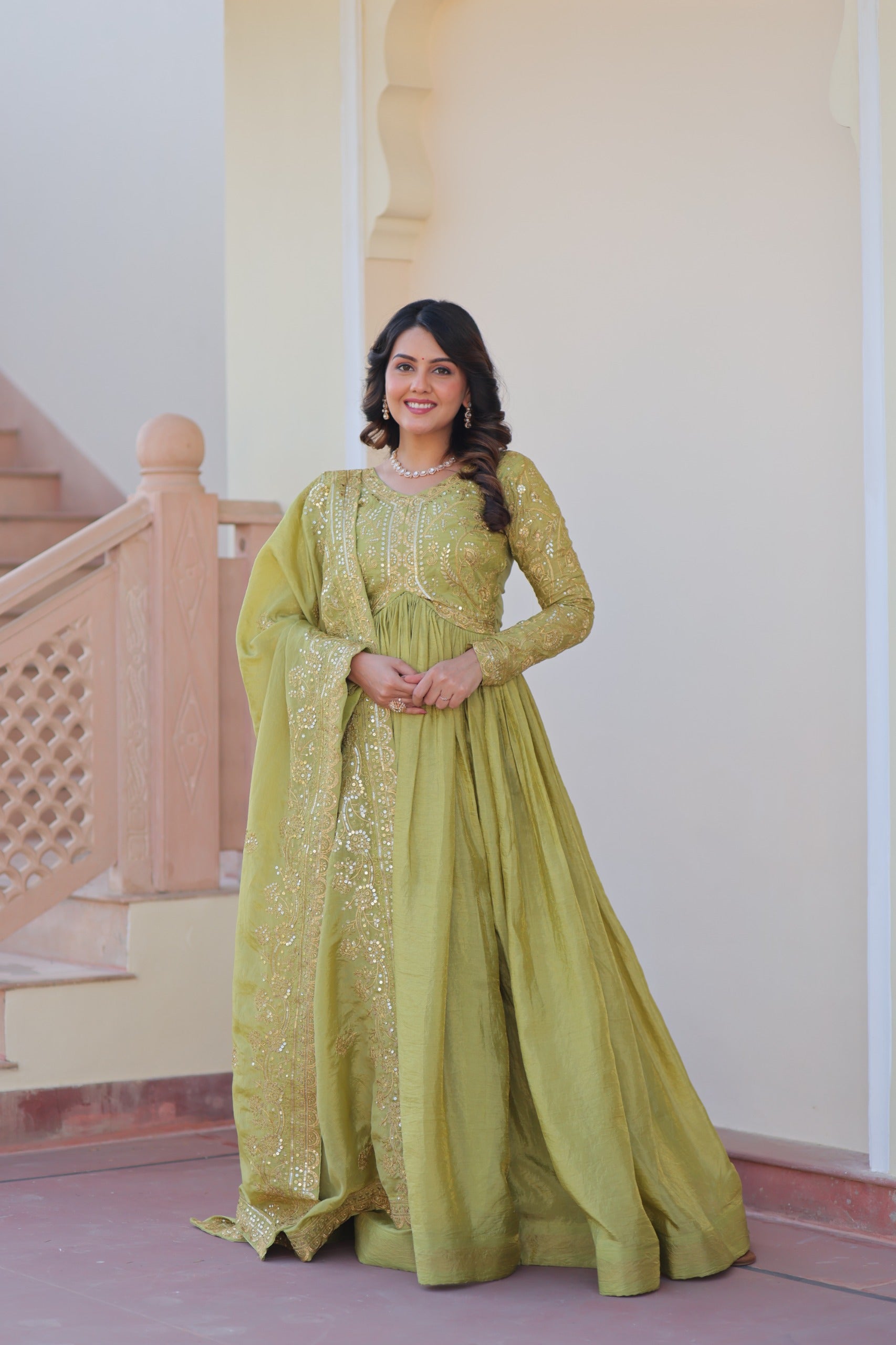 Vibrant parrot green gown in gold-crush fabric with sequins and intricate embroidery