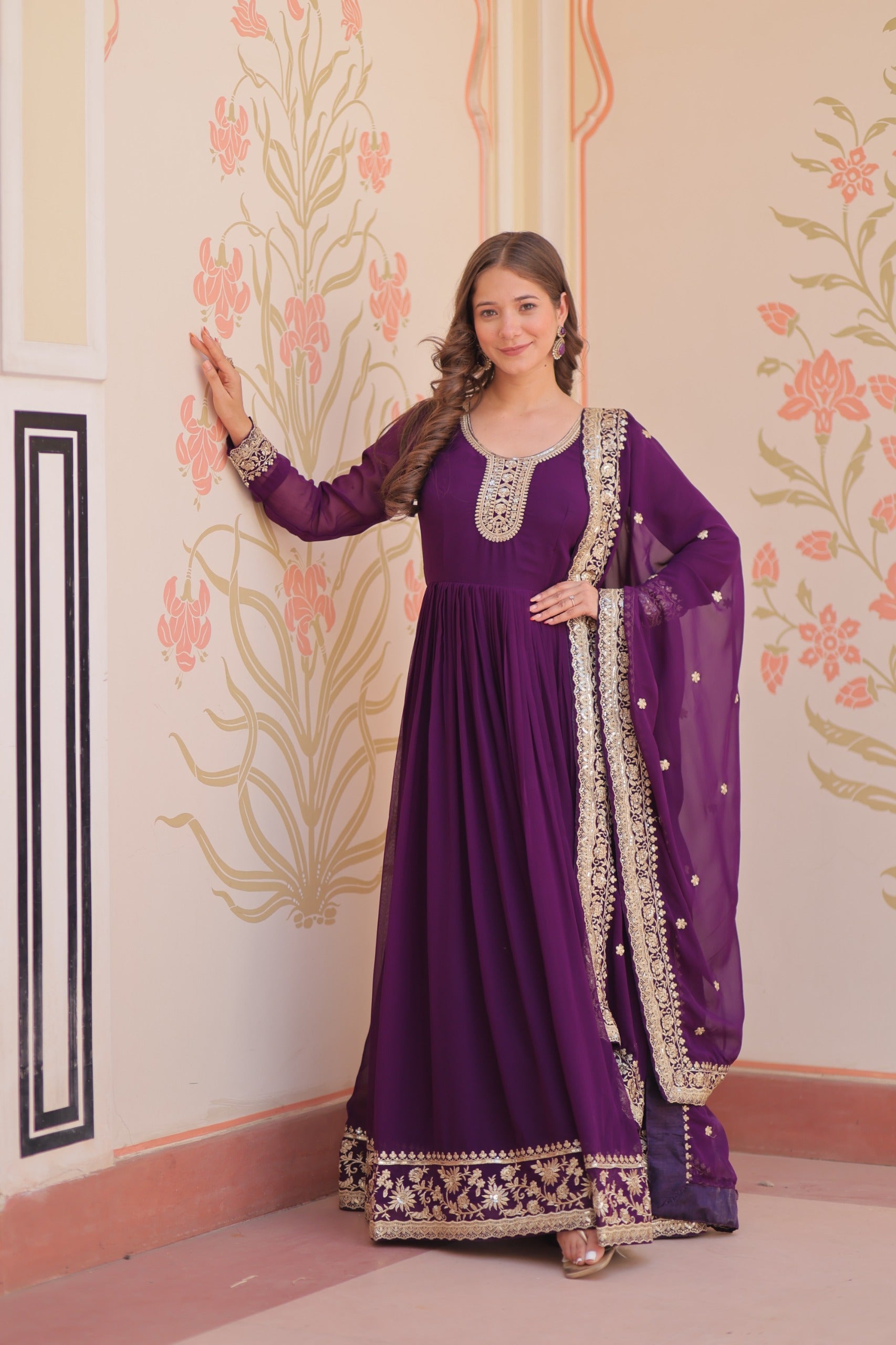 Purple georgette gown with heavy zari and sequins embroidery work.