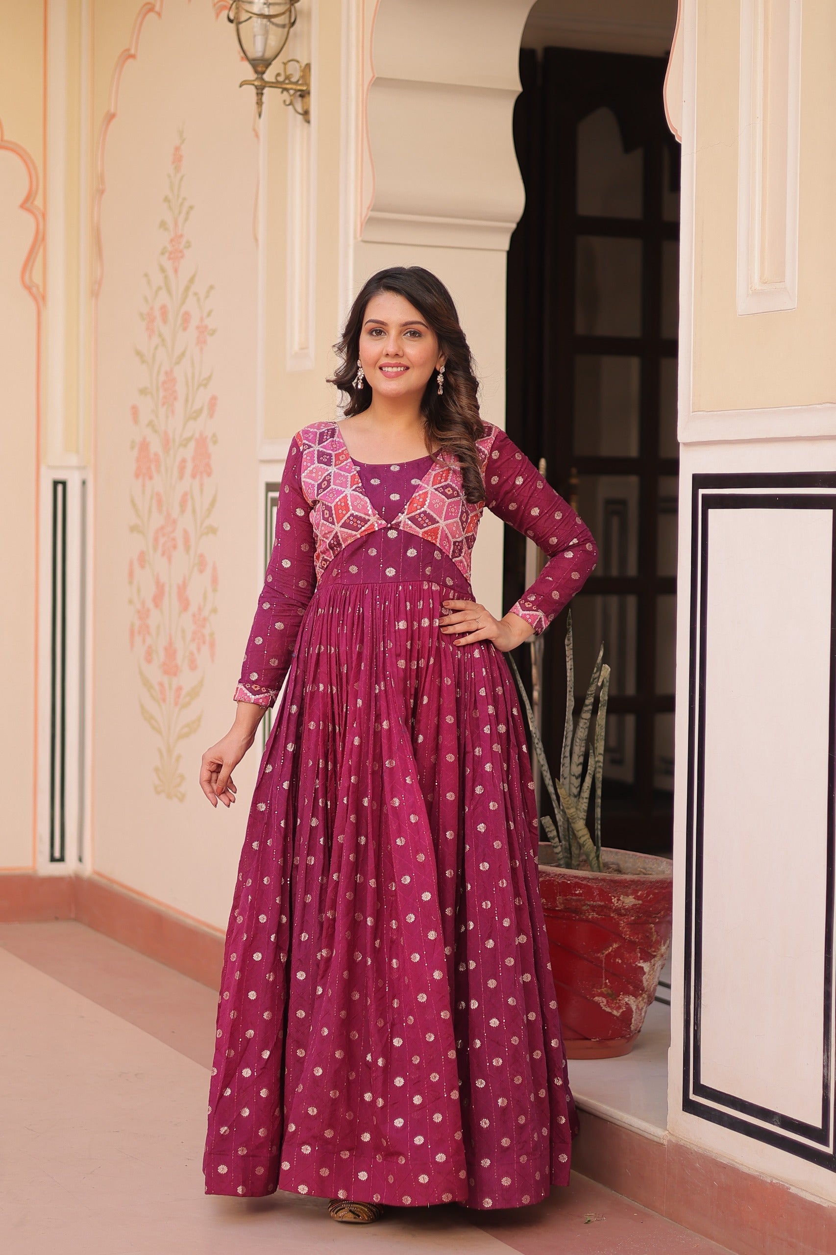 Wine colored gown featuring position print choli style and premium staple jacquard weaving detail.