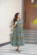Woman wearing a light blue printed faux georgette flared gown with 12-meter hem
