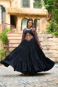 A black rayon ethnic gown featuring colorful Kutchi Gamthi embroidery and cotton print patterns.