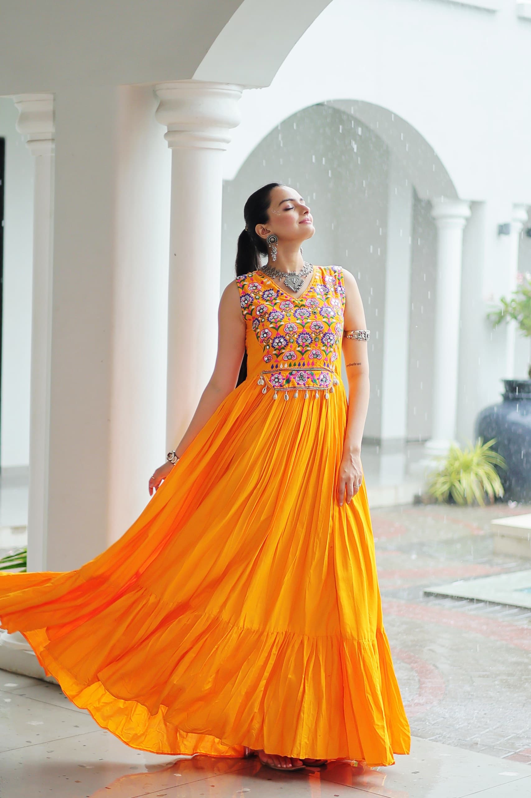 Yellow rayon gown with intricate thread embroidery and mirror work detailing