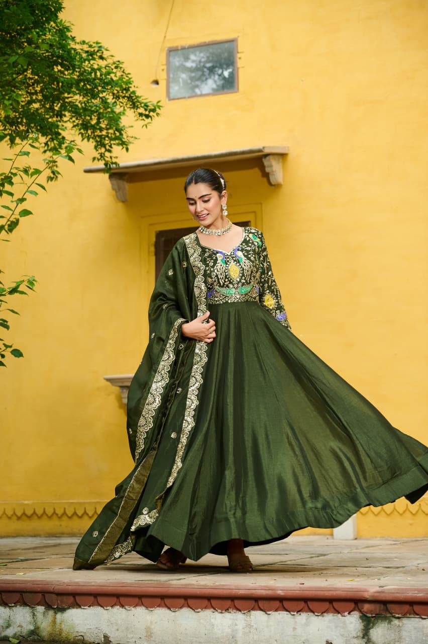 Woman wearing a decorative Mehendi Vichitra Silk embroidered gown with full sleeves and matching dupatta.