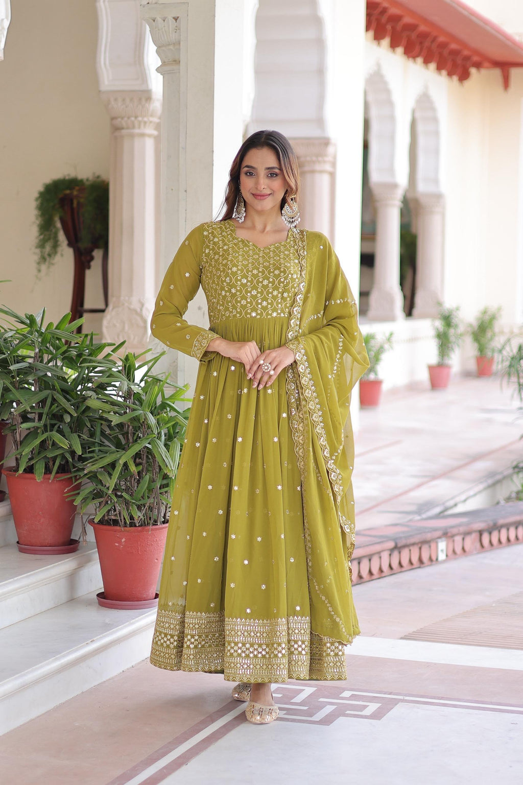 Mahendi green georgette gown with heavy sequins and zari embroidery