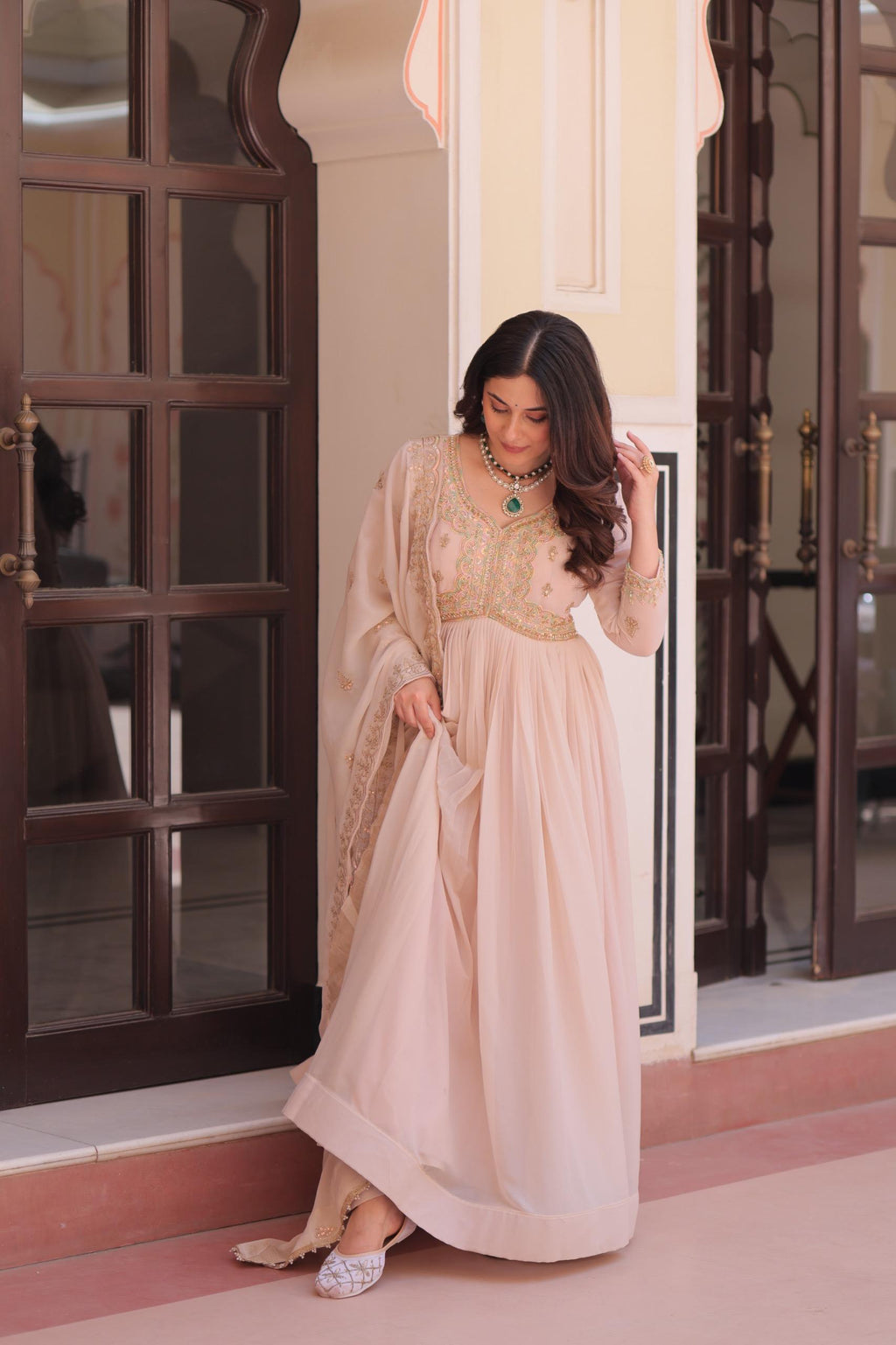 Cream star georgette gown decorated with detailed beads and sequin embroidery with matching dupatta.