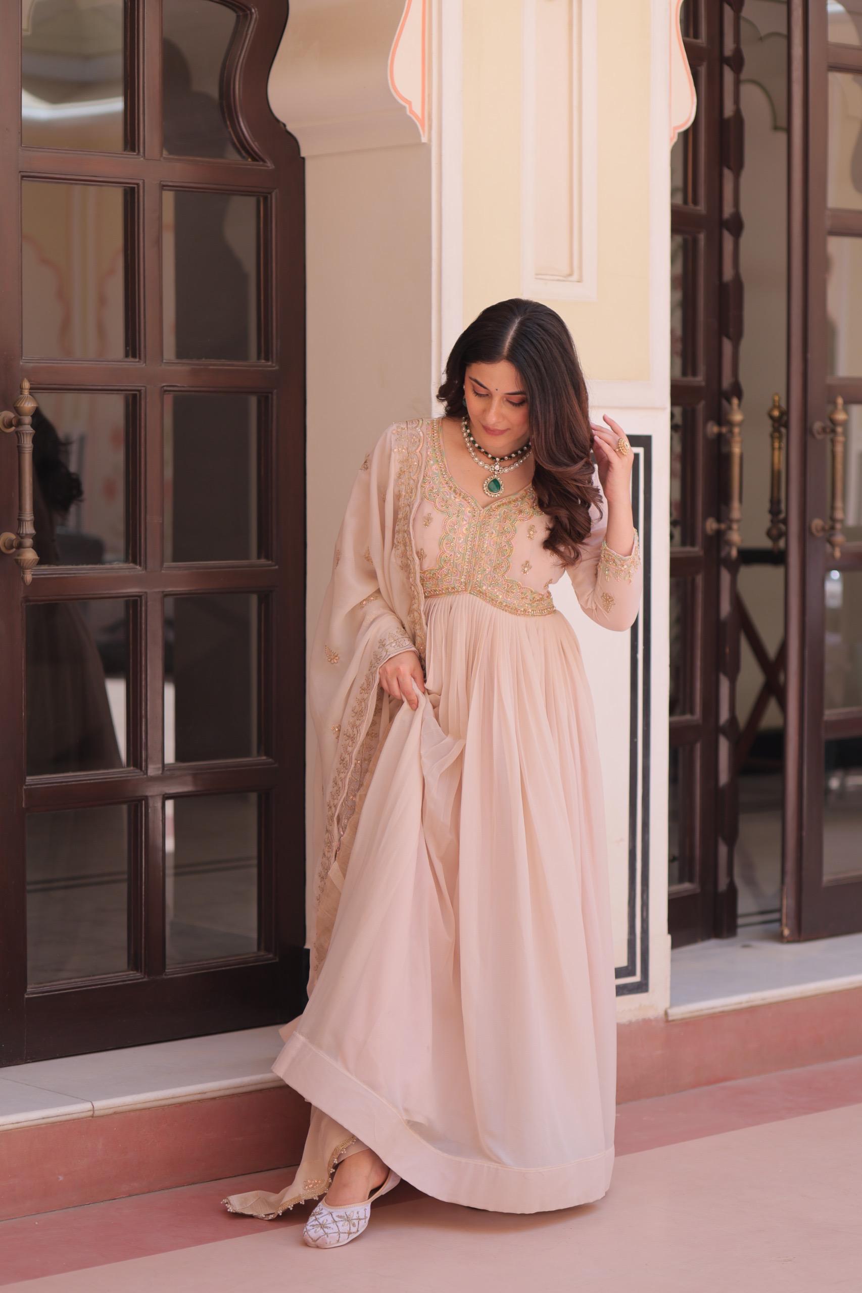 Cream star georgette gown decorated with detailed beads and sequin embroidery with matching dupatta.