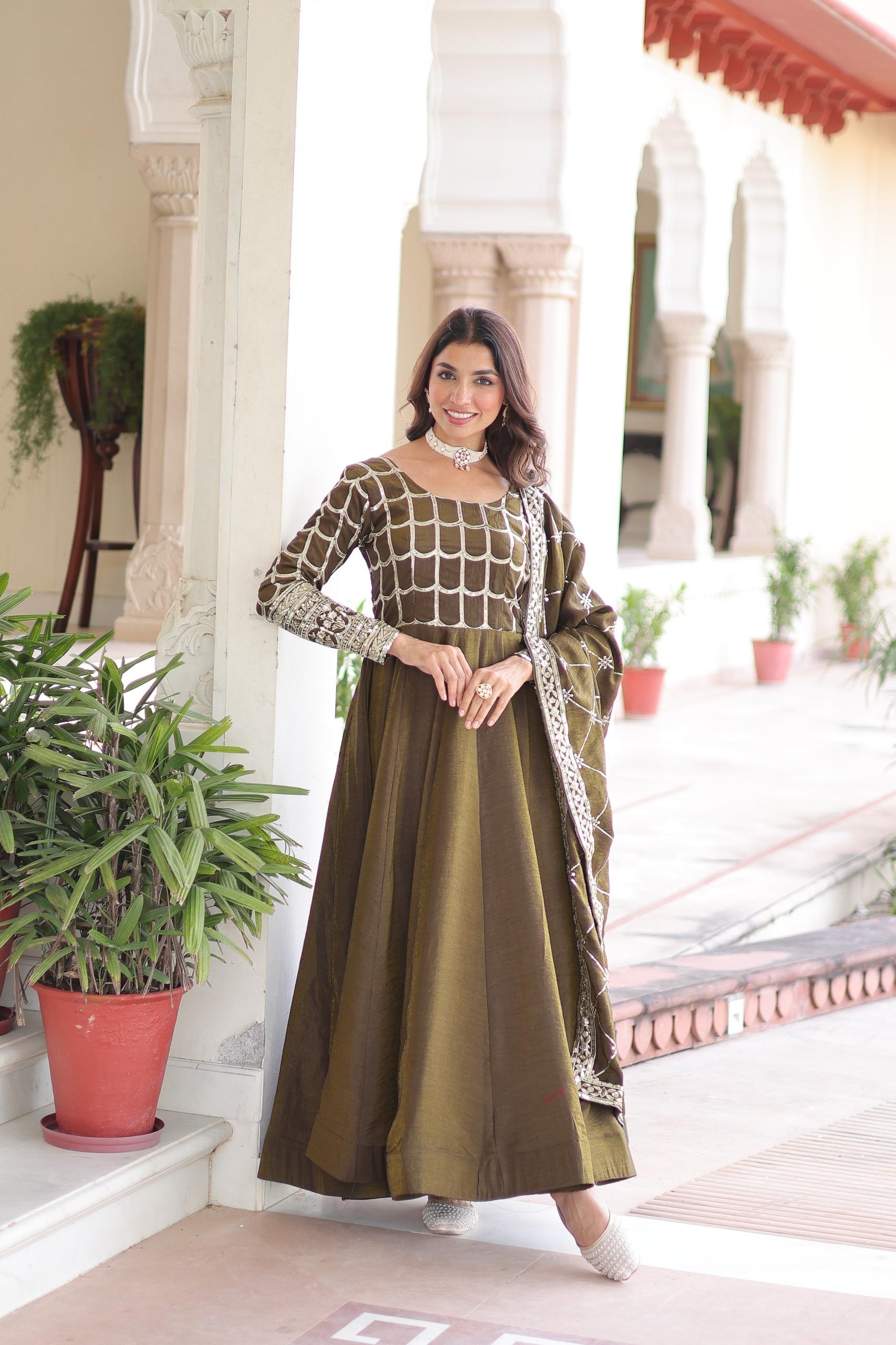 Mahendi colored Vichitra silk gown with detailed zari embroidery and sequins, featuring a flared skirt and long sleeves.