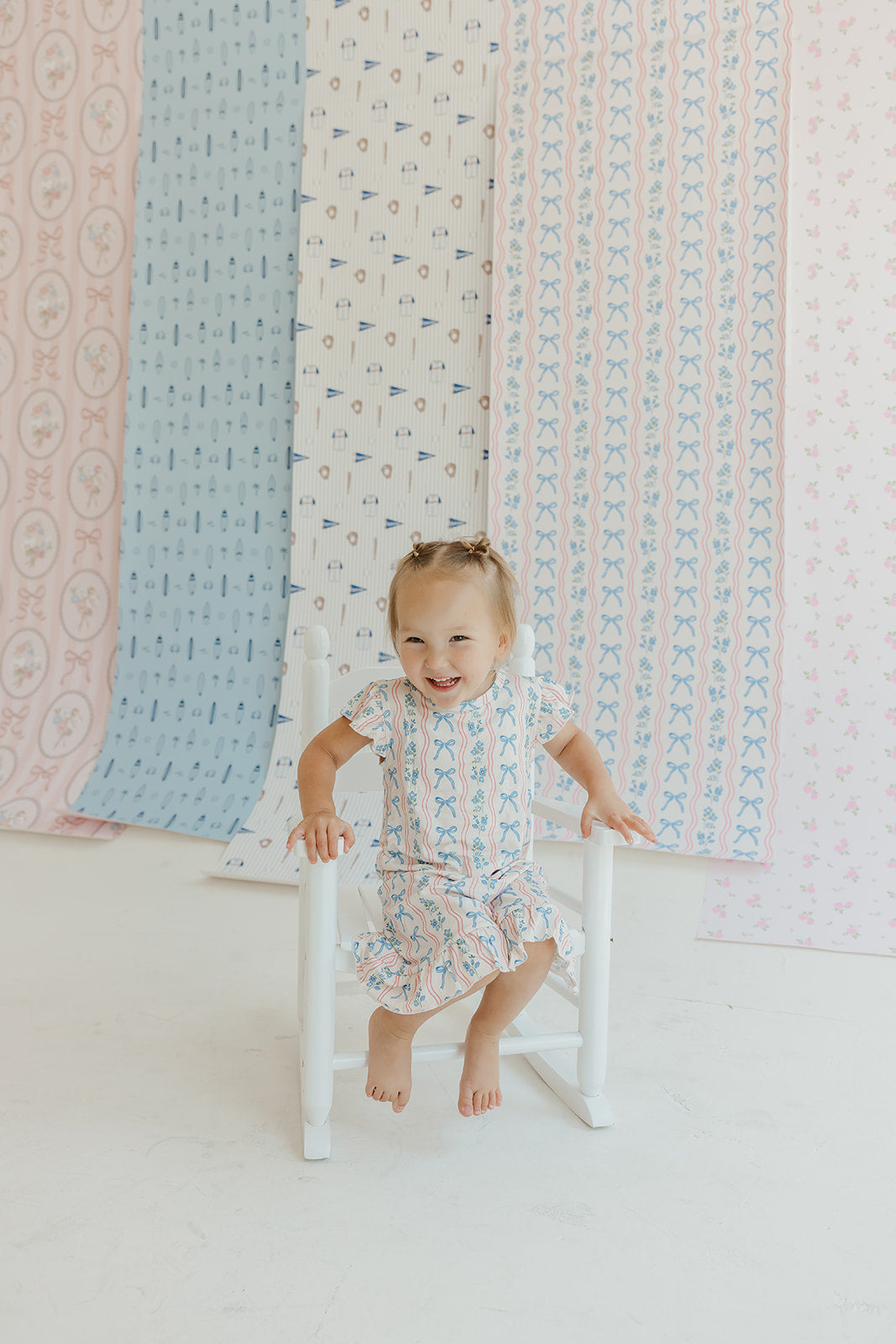 Amelia Bow Whimsical Nursery Wallpaper in Pink and Blue