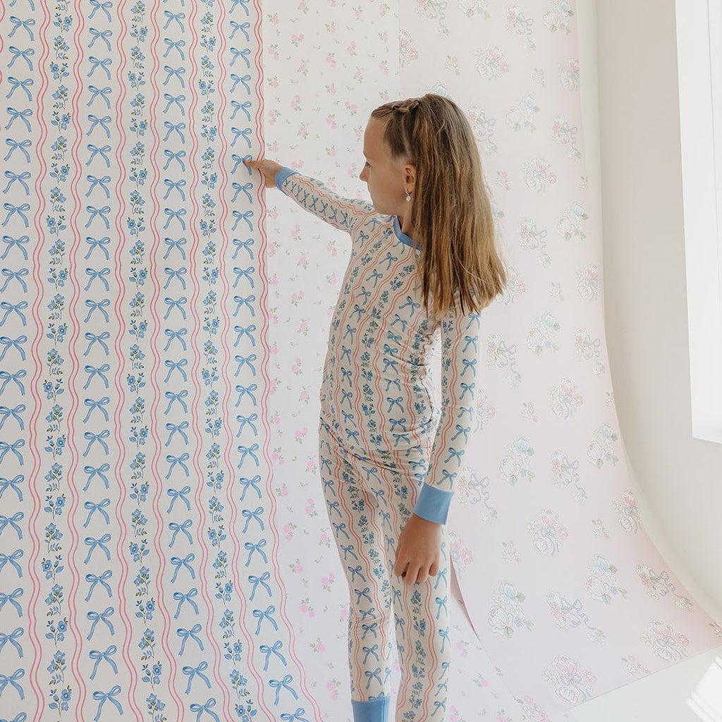Amelia Bow nursery wallpaper in pink and blue with a whimsical bow pattern