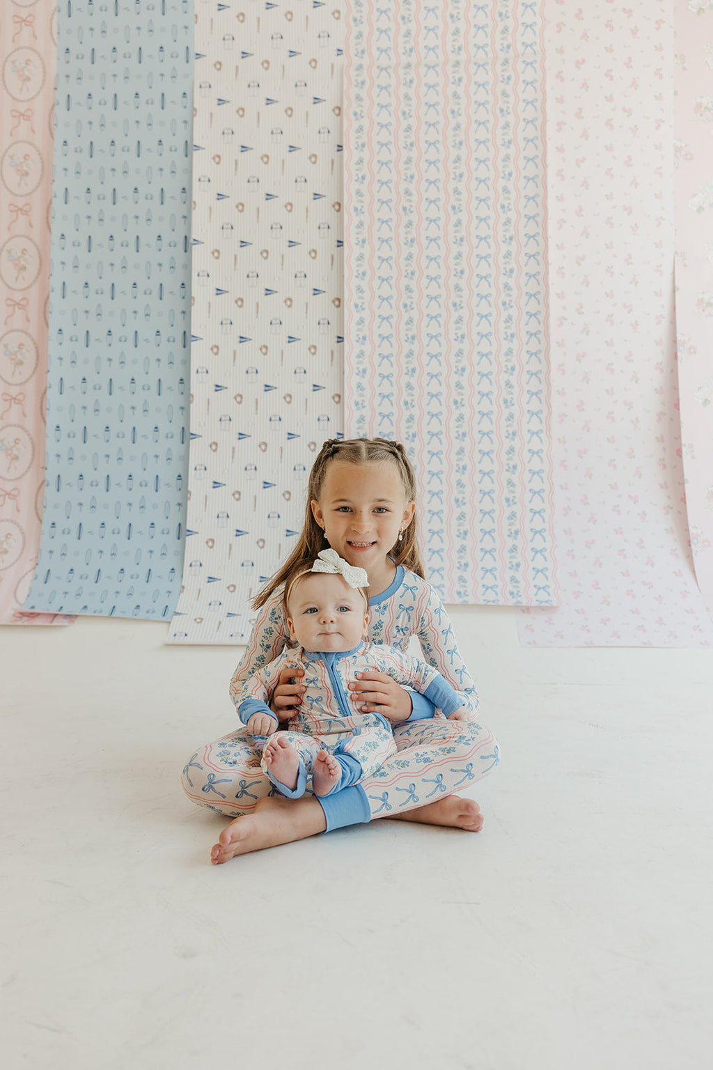 Amelia Bow Whimsical Nursery Wallpaper in Pink and Blue
