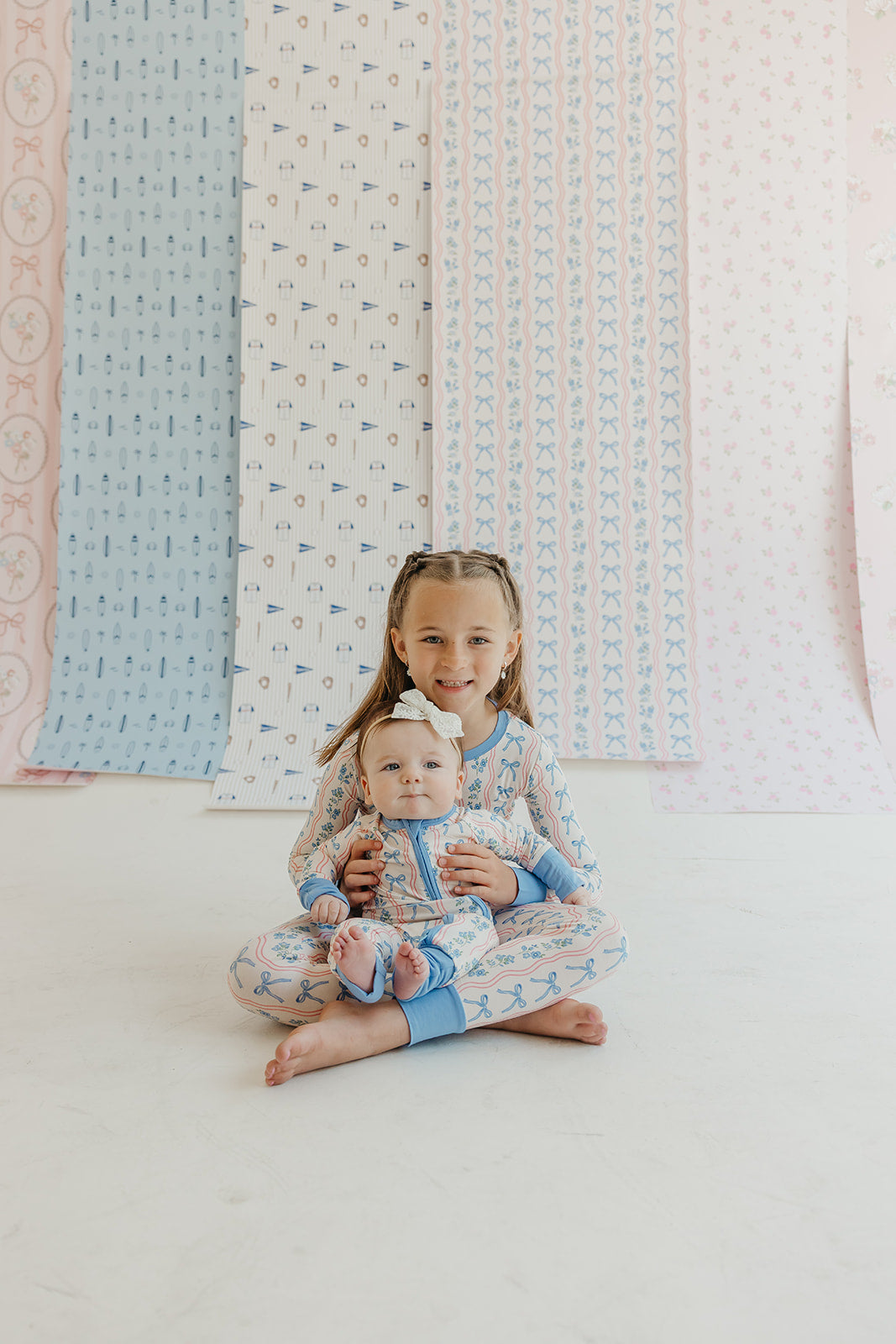 Amelia Bow Whimsical Nursery Wallpaper in Pink and Blue