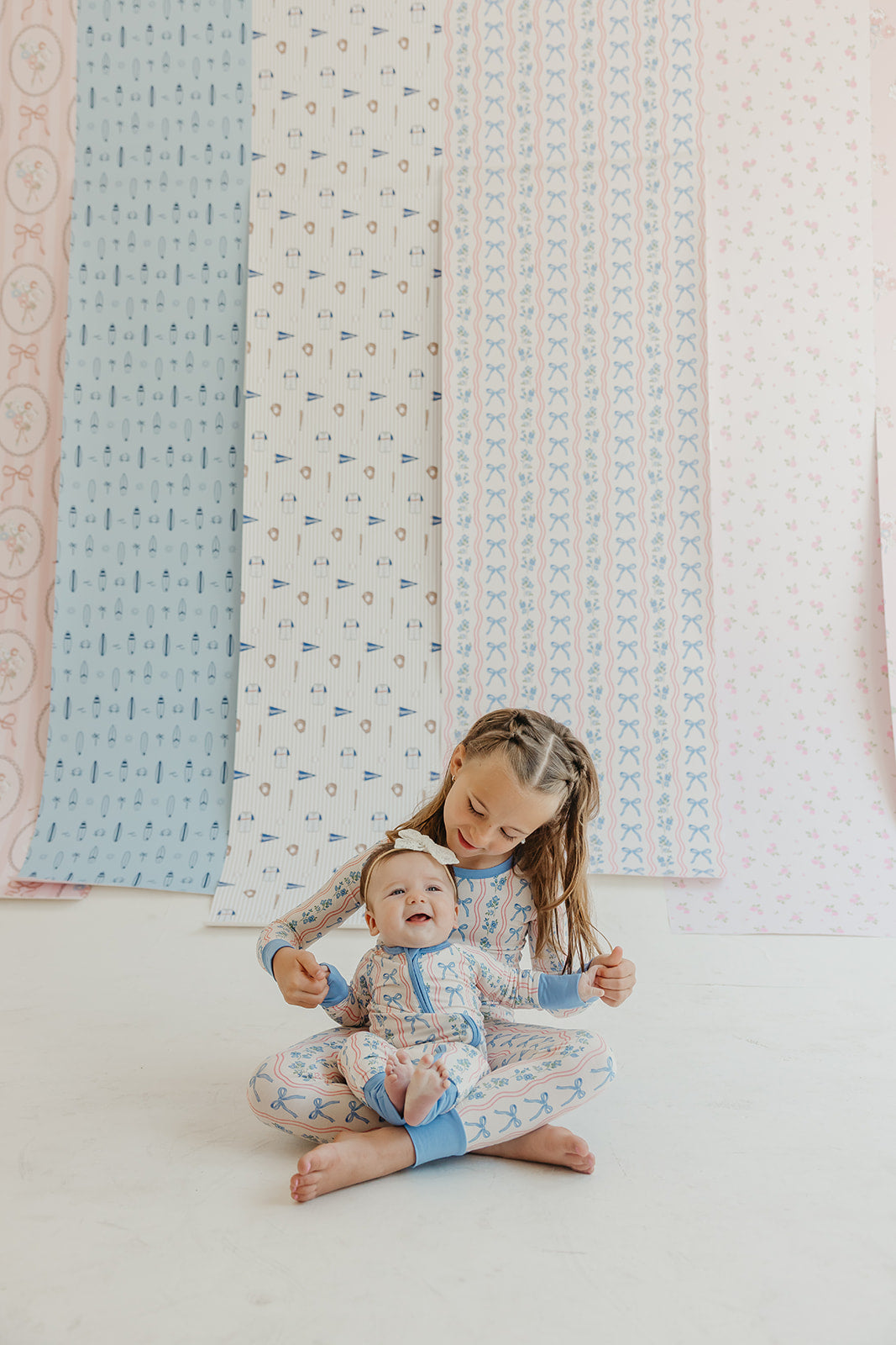 Amelia Bow Whimsical Nursery Wallpaper in Pink and Blue