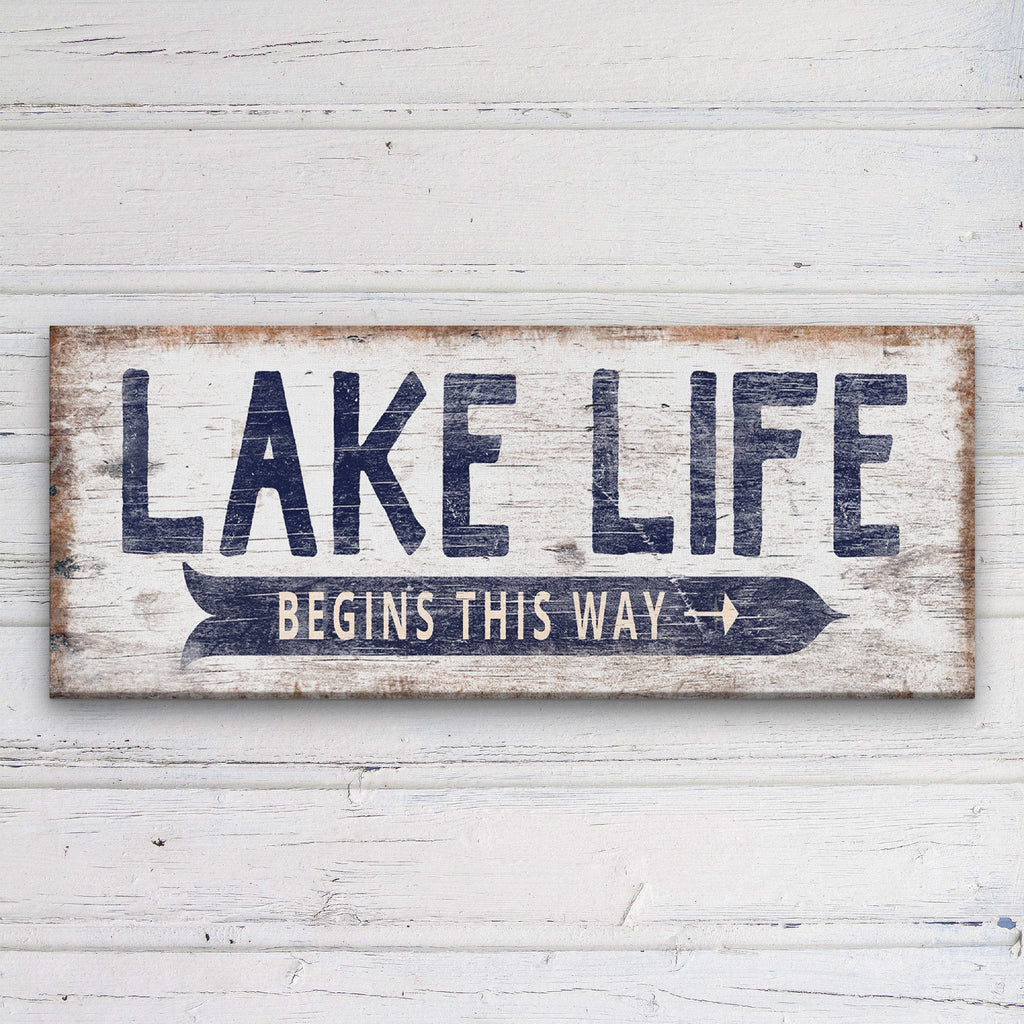 A rustic, hand-painted wooden directional sign with personalized text featuring a vintage Lake Life design.