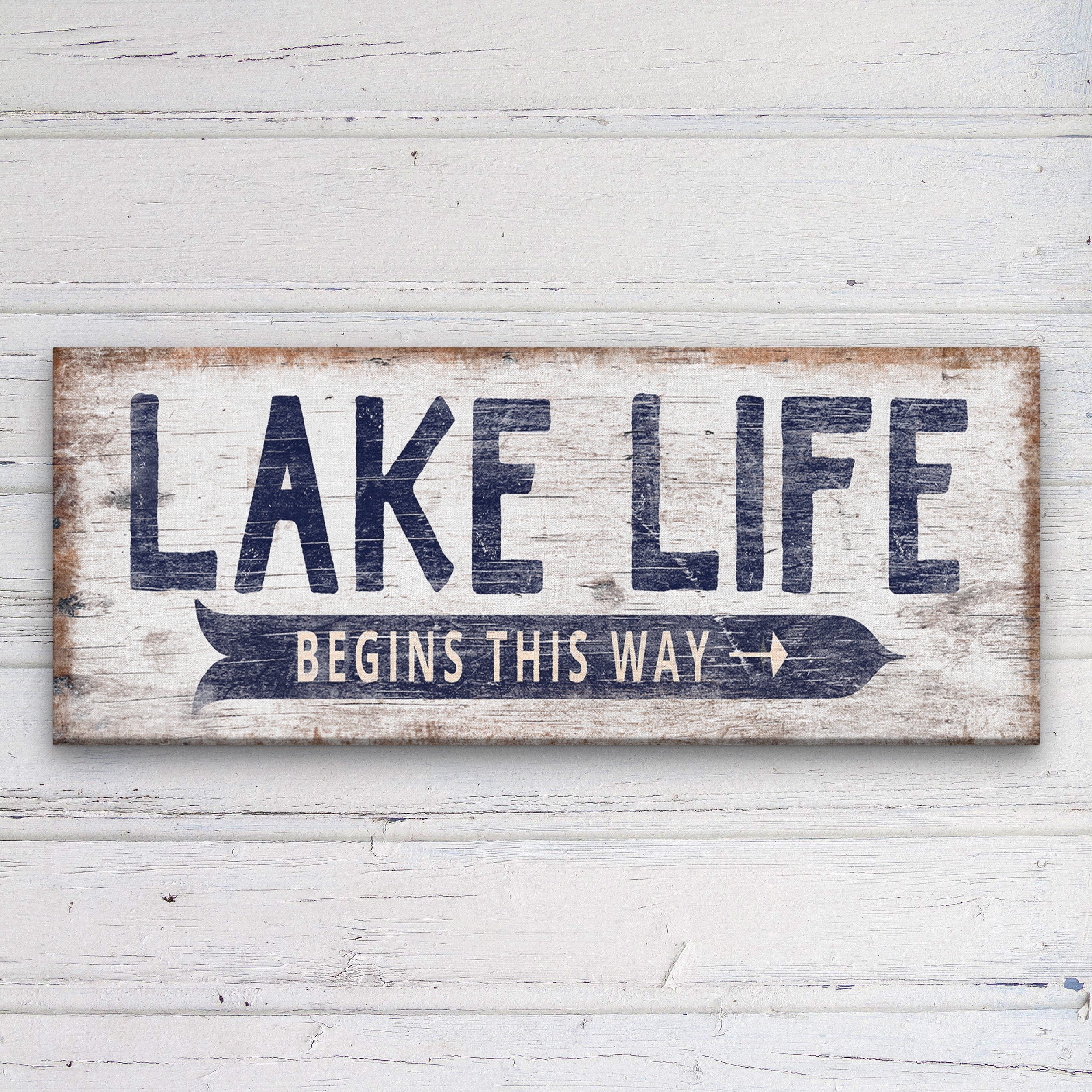 A rustic, hand-painted wooden directional sign with personalized text featuring a vintage Lake Life design.