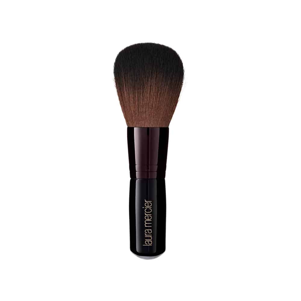 Tapered bronzer brush with a short handle for professional face makeup application.