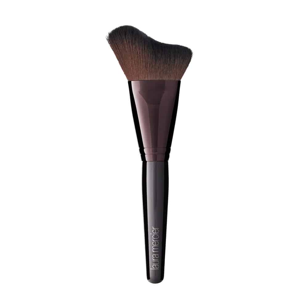 Curved glow powder brush with black and brown handle for professional makeup application.