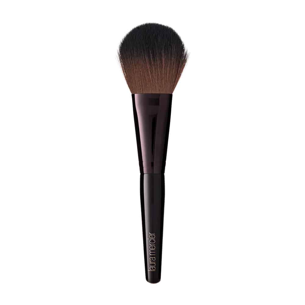 Sculpted makeup brush designed for applying loose setting powder.