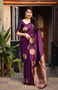 Purple soft silk saree featuring elegant gold zari woven butta patterns.