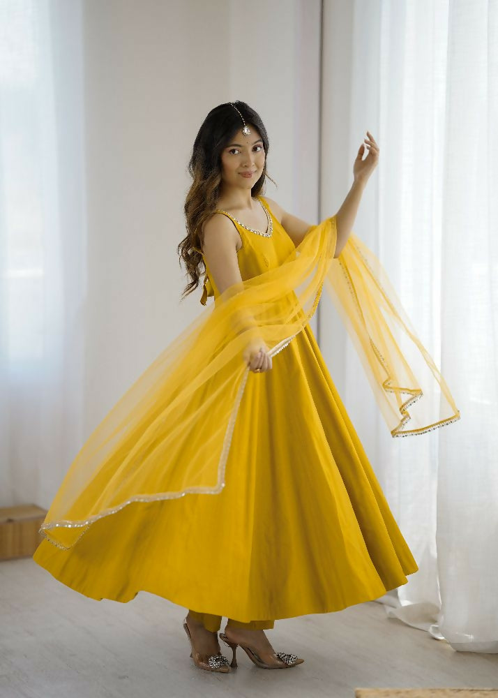 Woman wearing a yellow 3-piece Chanderi kurta set with sequence embroidery and a net dupatta