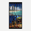 A rectangular beach towel with a photographic print of the Miami Beach skyline in bright blue and warm sunset colors.